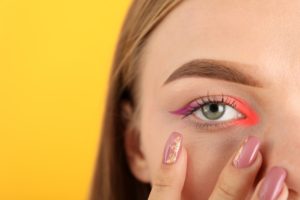 Beautiful model girl with makeup on yellow background