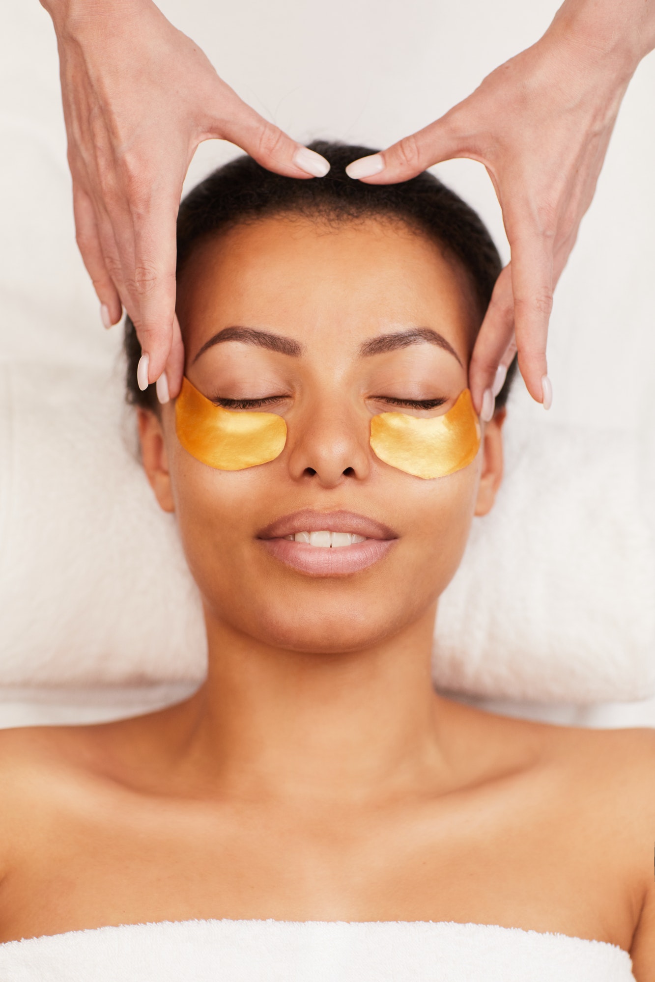 Young Woman Enjoying Facial Care in Spa